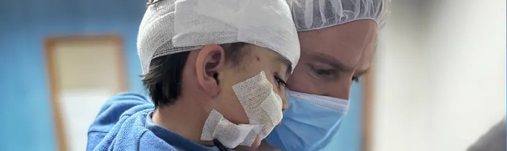 ICRC surgeon Jan holds Ziad.