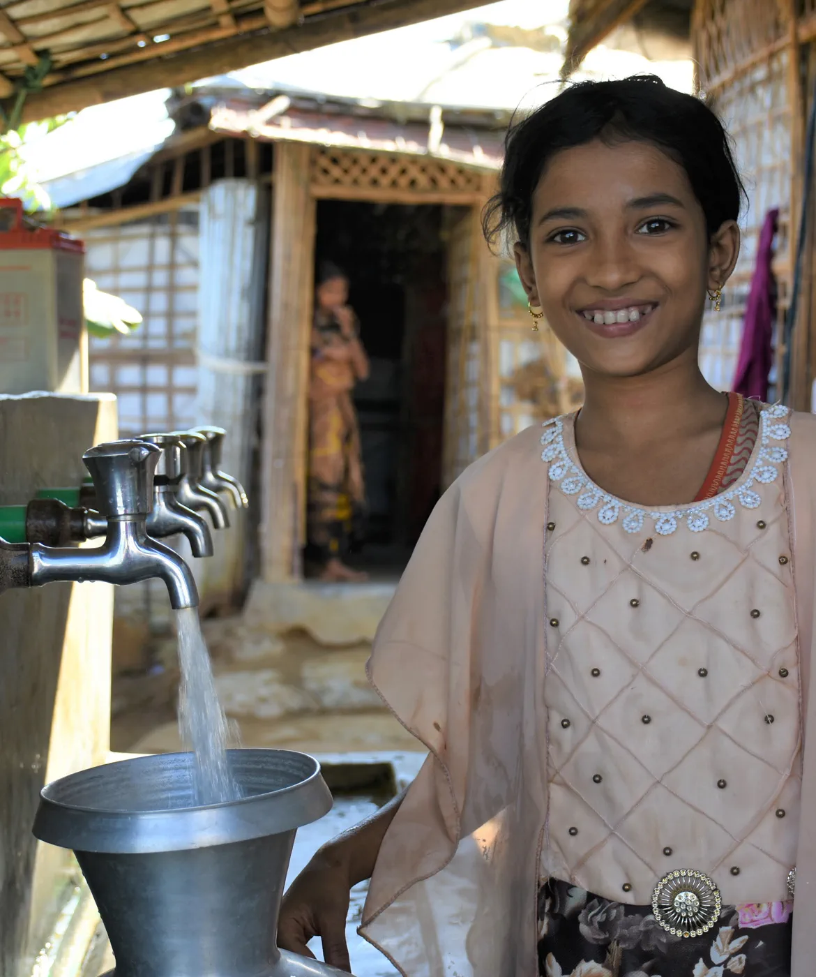 Girl in Cox Bazars using a water distribution point