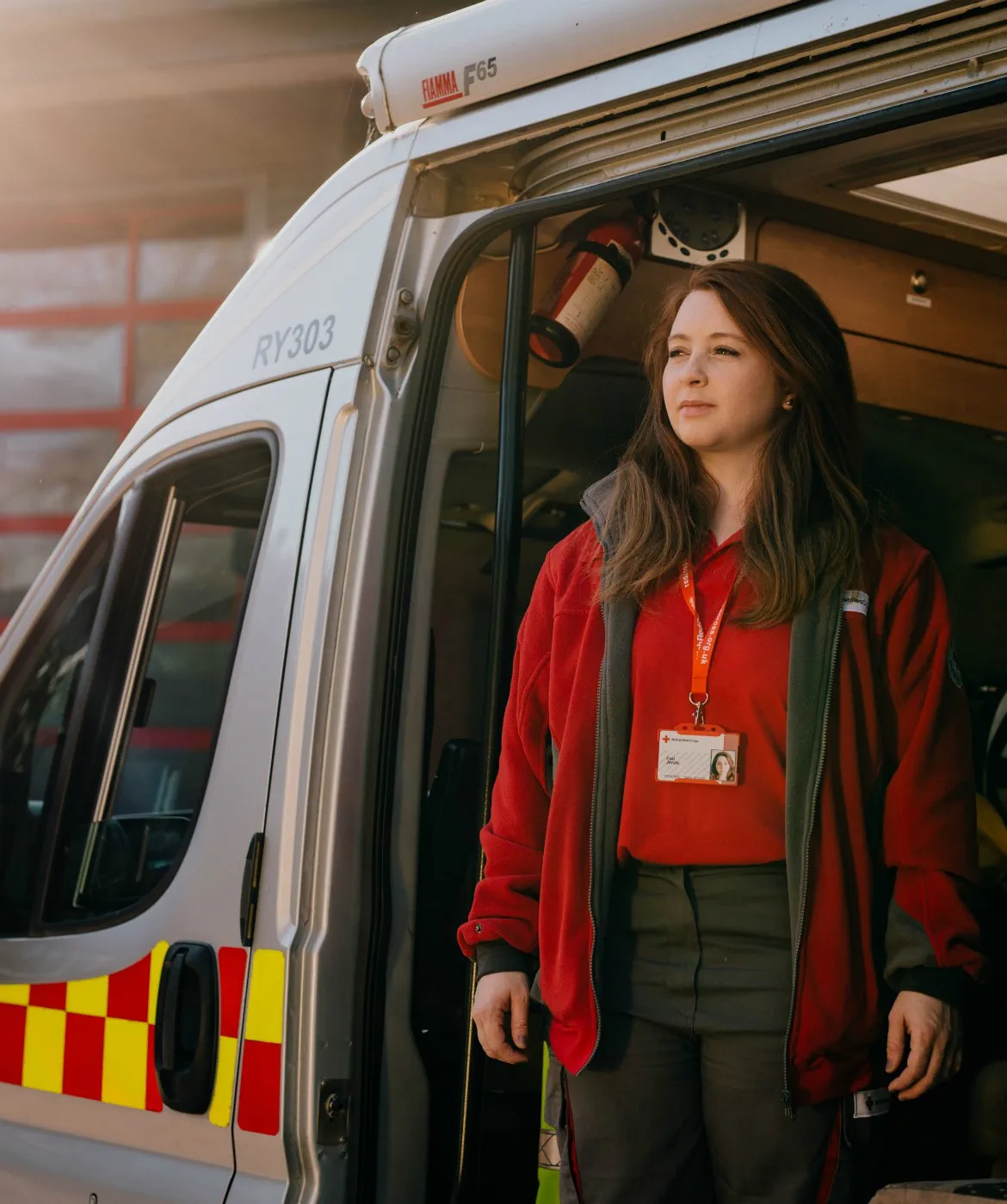 Red Cross Volunteer stands ready in Ambulance